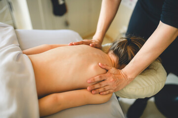 Professional masseur makes massage to a child girl