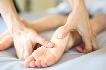 Professional masseur makes massage to a child girl