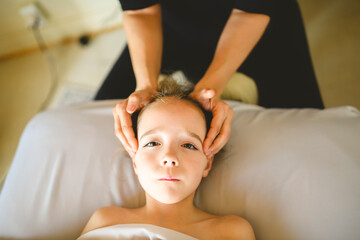 Professional masseur makes massage to a child girl
