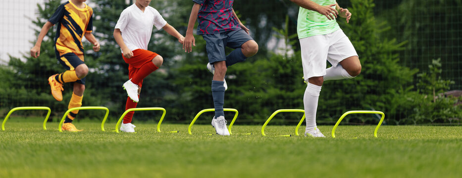 Youth Soccer Agility Drill with Hurdles; Kids Improving Speed and Coordination on Training Field