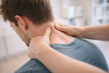 Fototapeta premium Professional massage therapy for neck pain relief in clinic sett