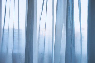 Transparent tulle white curtain, view from inside