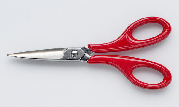 Pair of red scissors on a clean white background, studio shot