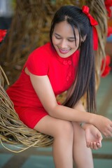 Cheerful Woman in Red Dress Celebrating New Year with Joyful Smile