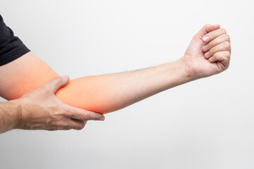 elbow, Close-up of a man holding his hand and touching his painful elbow joint, marked in red to indicate inflammation and pain. 