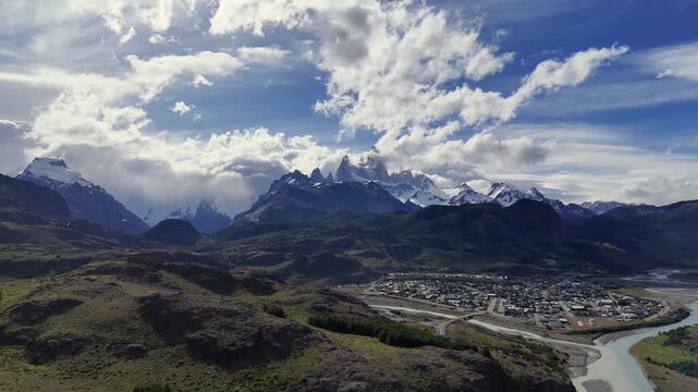 Cinematic aerial view of El Chalt&eacute;n mountain village with Mount Fitz Roy peaks at sunset, Patagonia Argentina