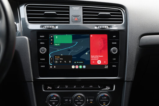 Google maps navigation and music player on screen in modern car. Volkswagen car interior - close-up shot of infotainment system with Android auto screencast. Kyiv, Ukraine - June 07 2025