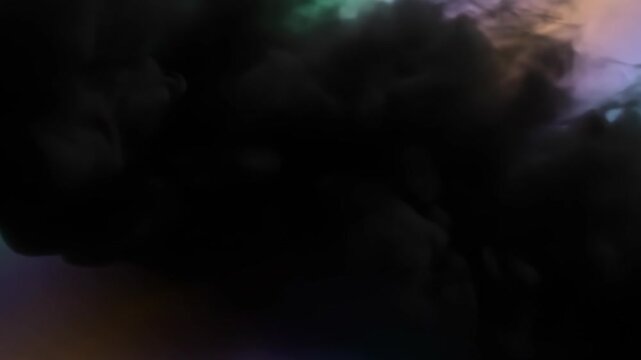 Abstract Black Ink Cloud Dissolving in Colorful Liquid Background.