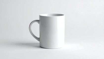 Fototapeta premium A plain, white ceramic mug with a curved handle stands on a bright white surface, subtly lit with shadows for depth. The design is simple, minimalist, and clean