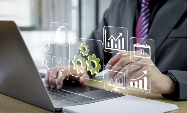 Businessman applies automation to optimize business process workflows, using technology and data analysis to improve productivity, efficiency, and effective operations management.