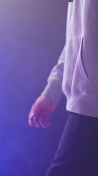 Headless person walk between neon lights in slow motion