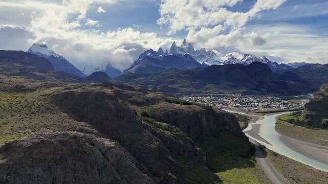 Cinematic aerial view of El Chalt&eacute;n mountain village with Mount Fitz Roy peaks at sunset, Patagonia Argentina