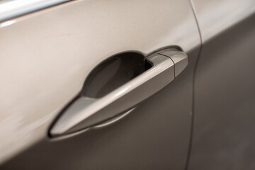 Silver car door handle detail on modern vehicle