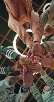 Below, school kids and hands stack with teamwork for success, academic growth and skill development. Children, happiness or huddle with celebration for collaboration, achievement or group solidarity.
