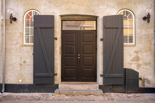 Architectural detail of stone facade with door shutters and entrance texture in copenhagen denmark offering timeless craft and calm mood