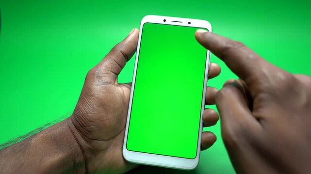 Hands Holding White Smartphone with Green Screen.