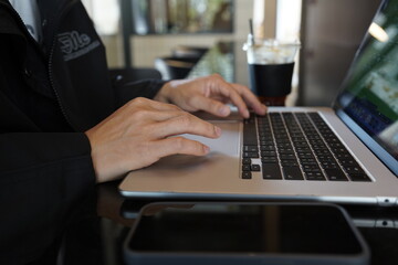 Close-up of hands typing on a laptop keyboard, remote work or digital nomad lifestyle.