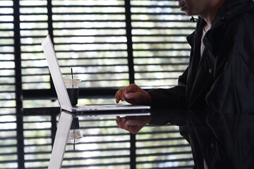 Close-up of hands typing on a laptop keyboard, remote work or digital nomad lifestyle.