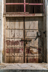 Carved wooden doors, hold merchant houses and narrow alleys in the city of Muharraq in Bahrain