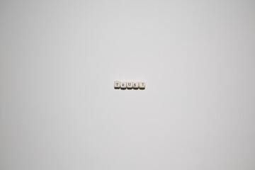 Fototapeta premium Minimal white background with letter blocks spelling trust. Concept for reliability, confidence, relationships, branding, and business credibility.