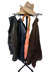coat rack with an orange umbrella and a few wicker hats