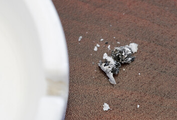 cigarette ash fallen outside the ashtray