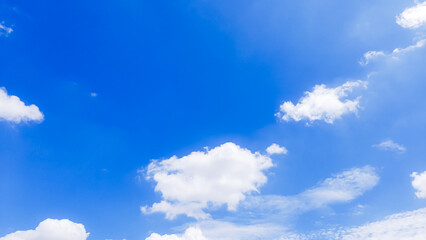 Fototapeta premium Bright blue sky background with soft white clouds and copy space for Blue Monday awareness or summer season designs featuring clear atmosphere and peaceful weather for corporate and social media