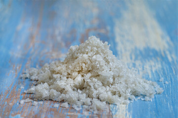 Salt Pile on Wooden Table With Blue Background