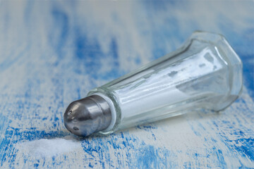 A Salt Shaker Rests on a Blue Wooden Table