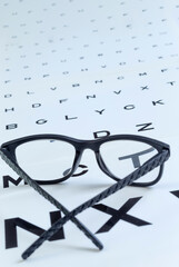 Glasses Placed on an Eye Test Chart in a Clinic