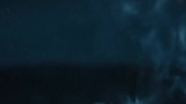 Glowing Ember Trails Medium shot focusing on the last, faint orange embers slowly falling, leaving subtle glowing trails against a deep, dark backdrop.