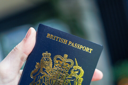 British passport held in hand in a modern lifestyle setting, representing travel, identity, and international mobility