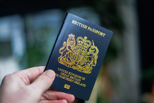 British passport held in hand in a modern lifestyle setting, representing travel, identity, and international mobility