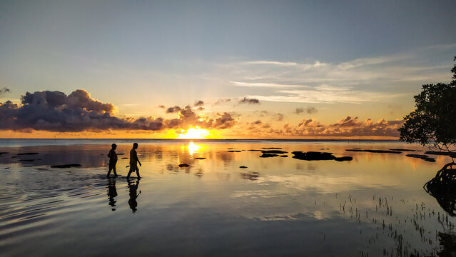 At Morer&eacute; Beach, the blue sea welcomes the sunrise and reflects warm tones at sunset on Boipeba Island, Bahia.