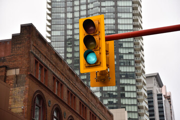 Naklejka premium Traditional and Modern Buildings Lining a Toronto Avenue with Traffic Light in Front, Ontario, Canada