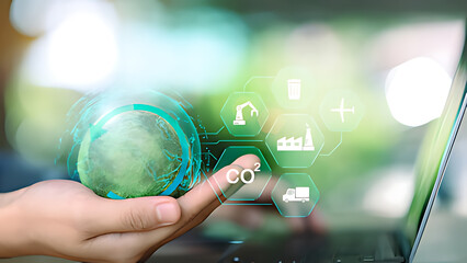 Sustainability manager managing global carbon footprint using digital technology and ESG industry icons. Concept of CO2 reduction, green supply chain, sustainable industry, circular economy