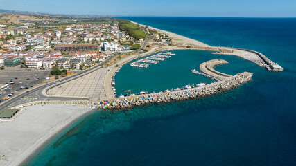 Aerial view of the Catanzaro Lido marina, located on the Ionian coast of Calabria, Italy. Many small boats anchored in the clean, blue harbor. It is a sunny summer morning. © Stefano Tammaro