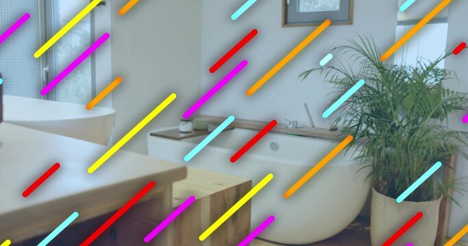 Showing freestanding white oval bathtub sitting at right in bathroom, with potted palm and vanity