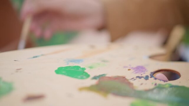 Energy flows through vibrant strokes. Lively brush movements bring vivid colors to life on wood. Colorful and energetic painting techniques produce expressive artwork on wooden surfaces