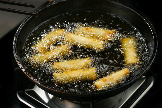 Golden Crispy Spring Rolls Deep Frying in Oil - Delicious Dim Sum Appetizers
