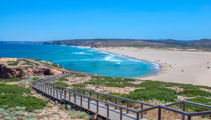Naklejka premium view on Praia de Bordeira (Bordeira beach), beautiful beach and wooden foothpath going to the seaside Algarve, Portugal