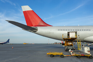Loading a baggage container into the luggage compartment of a passenger aircraft at an airport
