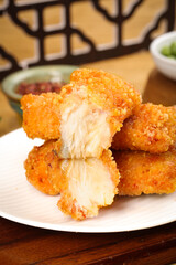 Crispy Fried Fish Nuggets with Spicy Flavors and Dipping Sauces on White Plate