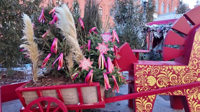 Russia, Moscow. 22 February 2025. festive russian troika cart with horse sculpture, decorated with ribbons and evergreens, at maslenitsa festival