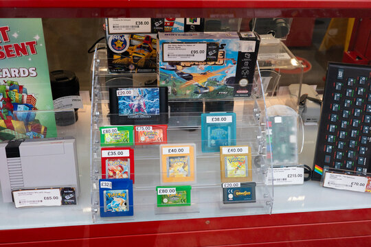 Newcastle upon Tyne UK: 17th Nov 2025: A display case shows a selection of retro game cartridges and accessories in a CEX store. Prices and game titles. Pokemon Gameboy