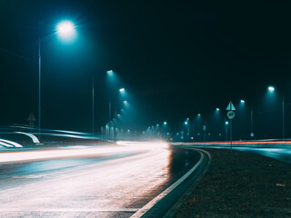 Naklejka premium Foggy night highway , car tracks