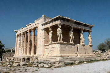 The ancient Erechtheion temple with its Porch of the Caryatids against a vibrant blue