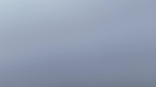 Drone Ascending Through Marine Layer Clouds on Overcast Day