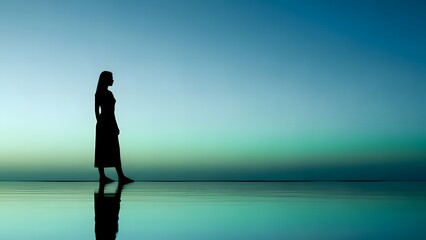Fototapeta premium Woman silhouette standing on rock at golden hour seaside sunset reflection peace