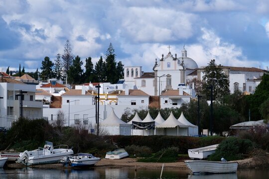 View across the Gil&atilde;o River to the whitewashed houses of Tavira, Algarve, Portugal, Europe